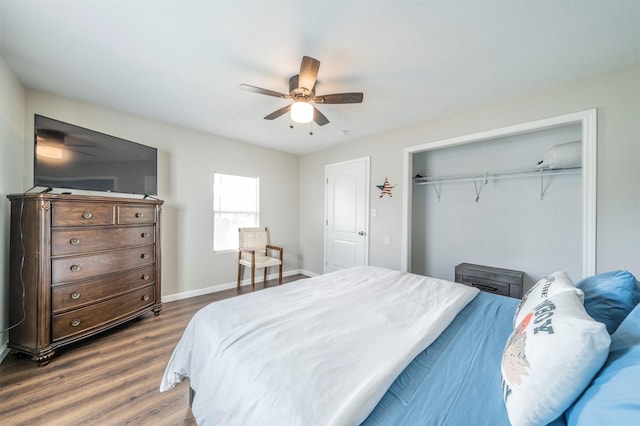 bedroom featuring ceiling fan, dark hardwood / wood-style flooring, and a closet