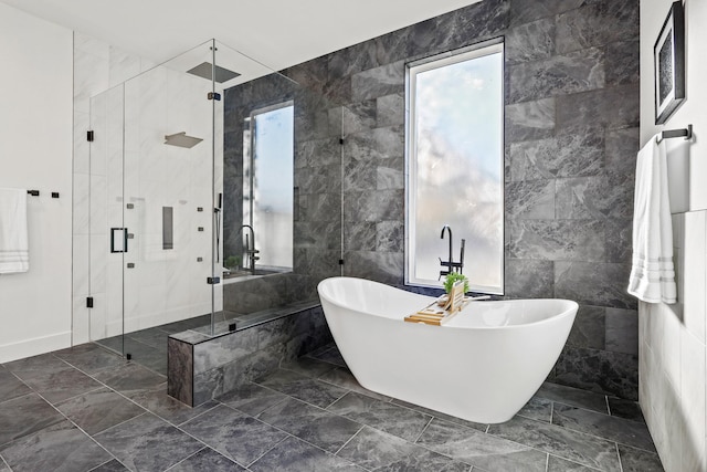 bathroom featuring tile walls and separate shower and tub