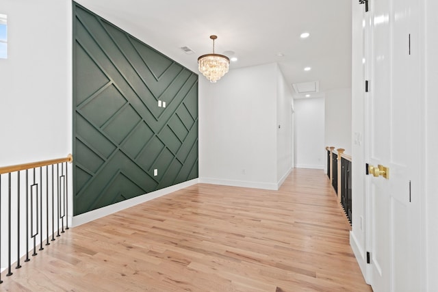 interior space with an inviting chandelier and light hardwood / wood-style floors