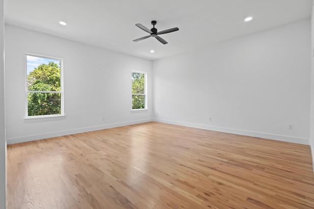 empty room featuring ceiling fan and light hardwood / wood-style flooring