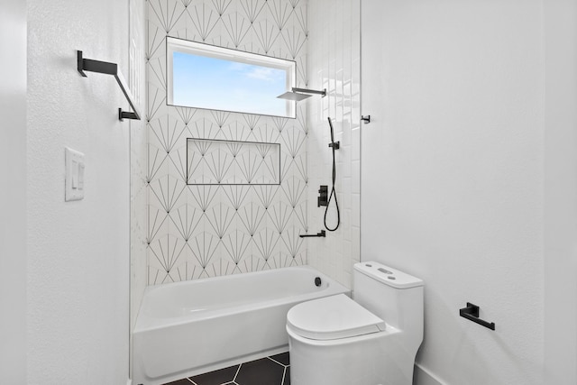 bathroom featuring toilet, tiled shower / bath combo, and tile patterned flooring