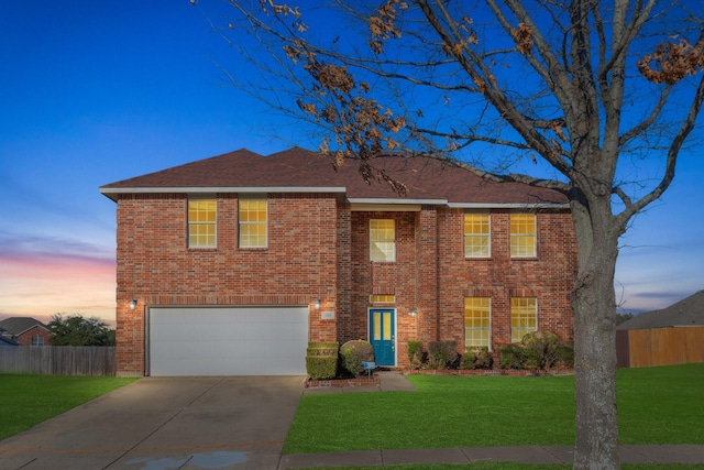 view of front of property with a yard and a garage