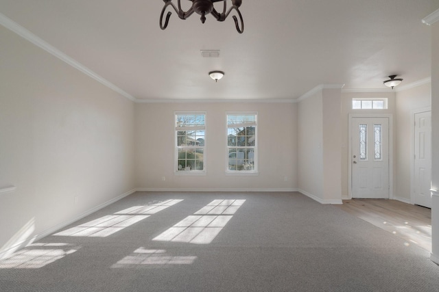 unfurnished living room with ornamental molding, light colored carpet, and a notable chandelier