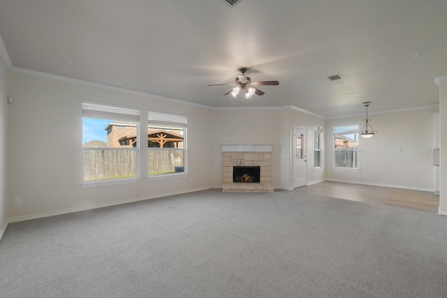 unfurnished living room featuring ceiling fan, light colored carpet, a stone fireplace, and ornamental molding