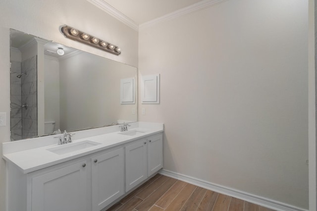 bathroom featuring toilet, ornamental molding, and vanity