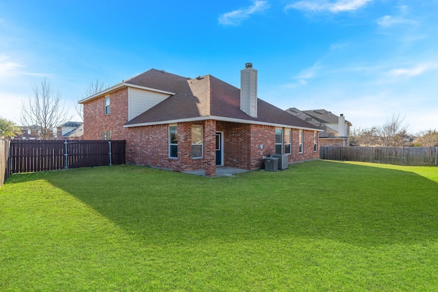 rear view of house with a lawn