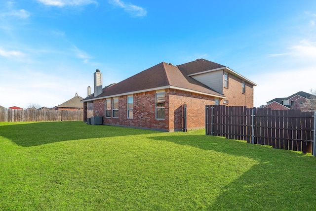 exterior space with a yard and central AC