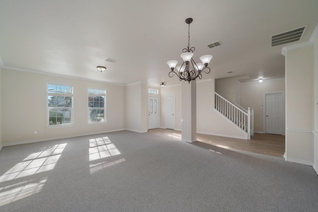 unfurnished living room featuring ornamental molding, a notable chandelier, and light colored carpet