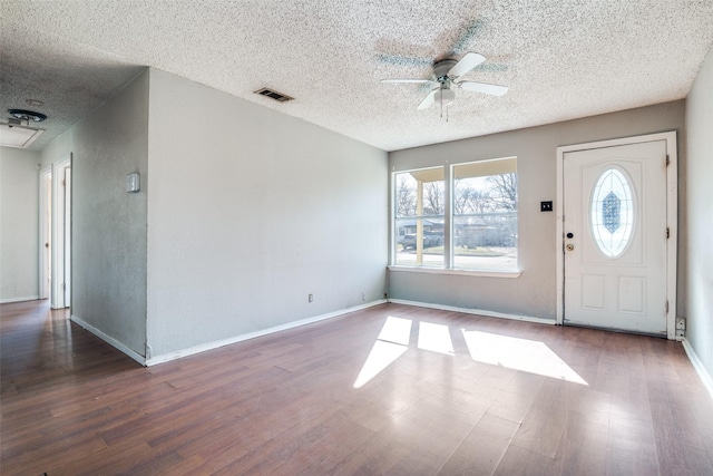 foyer featuring a textured ceiling, ceiling fan, and dark hardwood / wood-style flooring