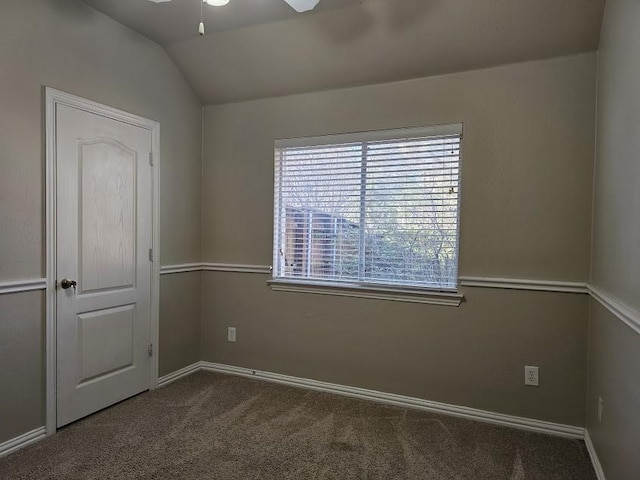 carpeted empty room featuring lofted ceiling and ceiling fan