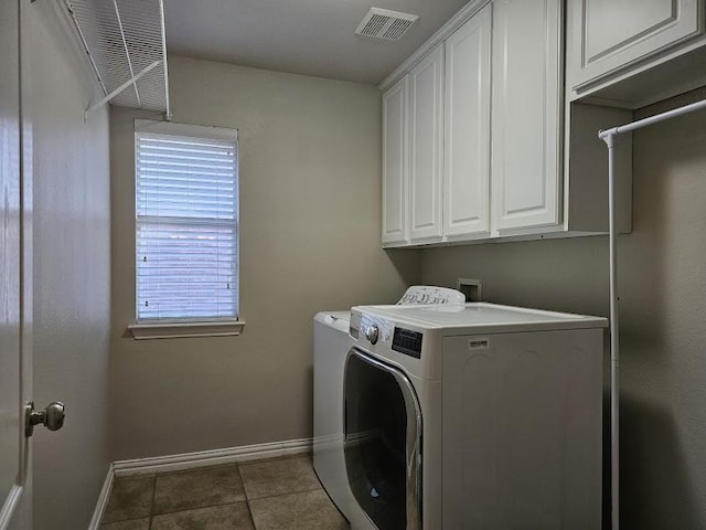 washroom featuring cabinets, washer and clothes dryer, and tile patterned flooring