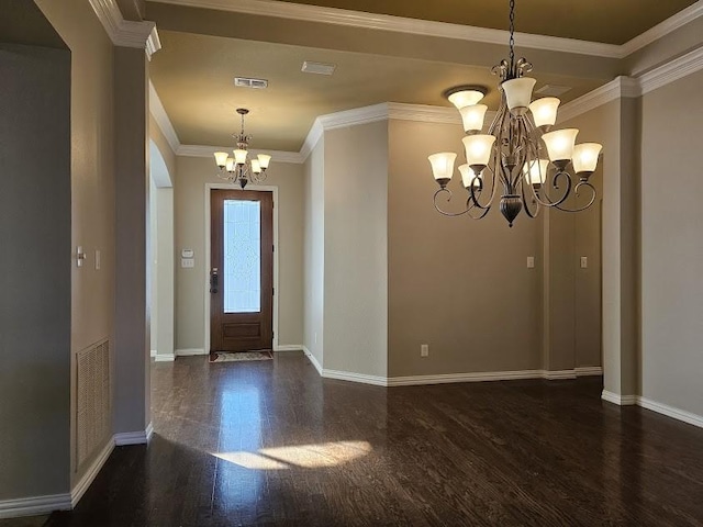 foyer entrance featuring dark hardwood / wood-style flooring, crown molding, and a notable chandelier