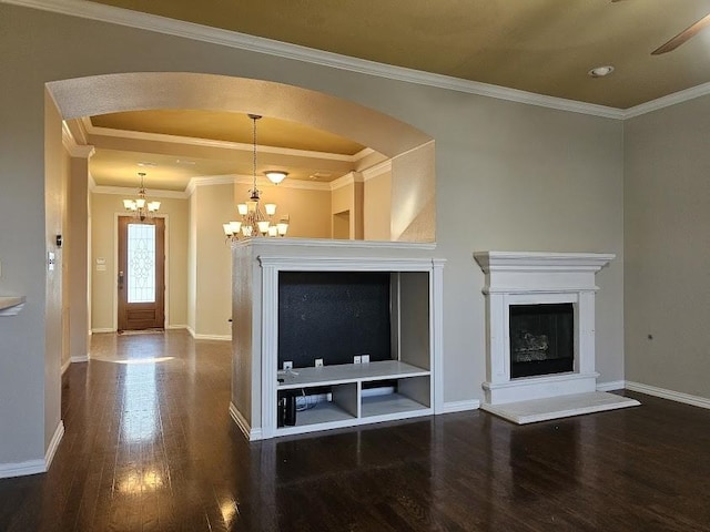 living room with ceiling fan with notable chandelier, crown molding, and dark hardwood / wood-style flooring