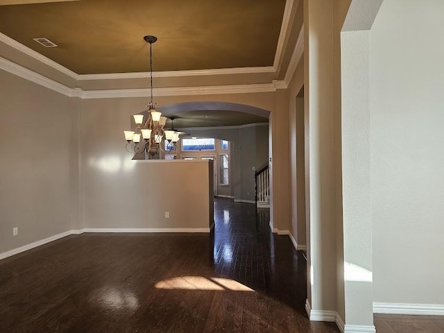 unfurnished dining area with an inviting chandelier, crown molding, and dark hardwood / wood-style floors