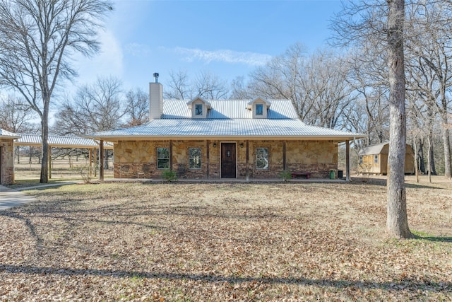 farmhouse inspired home featuring a porch and a carport