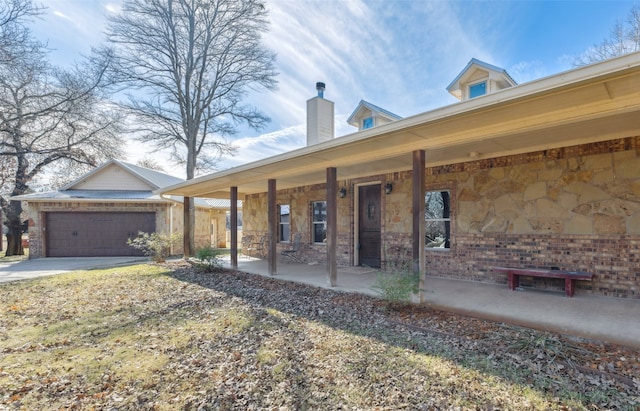 view of front of house with covered porch and a garage