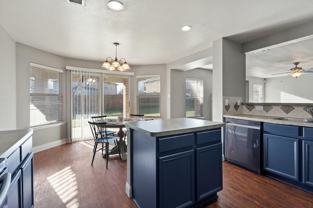 kitchen with decorative light fixtures, dishwasher, blue cabinetry, and a center island