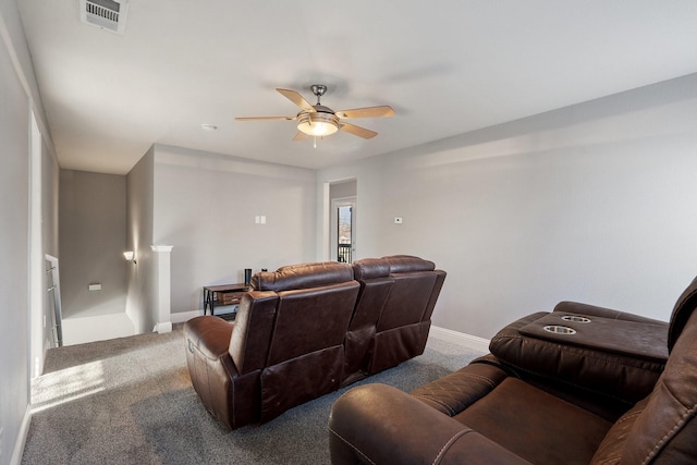 carpeted home theater featuring ceiling fan