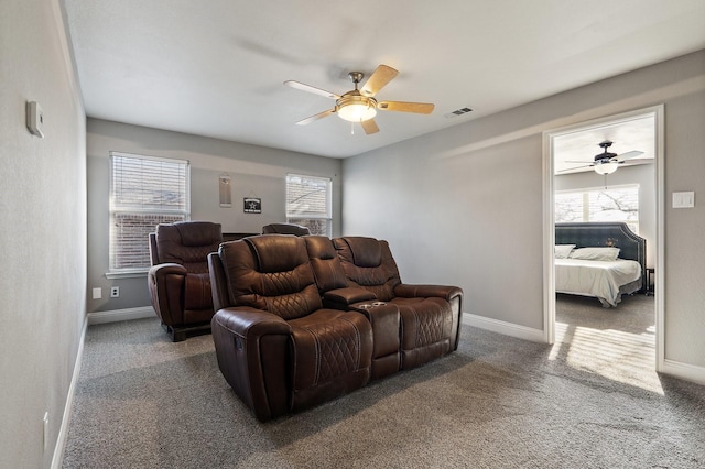 interior space featuring ceiling fan and dark colored carpet