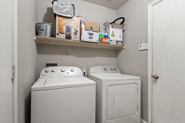 washroom featuring washing machine and clothes dryer and a textured ceiling