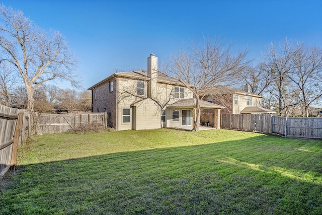 rear view of property with a patio area and a yard