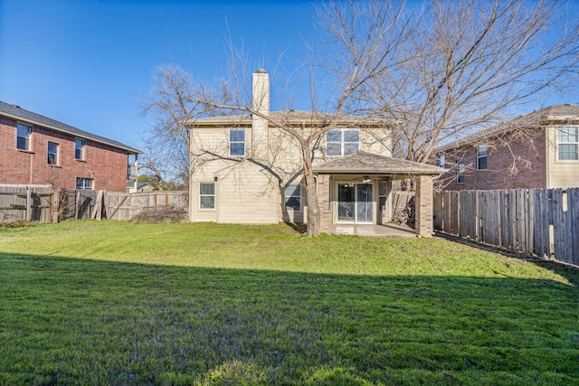 back of house featuring a lawn and a patio area