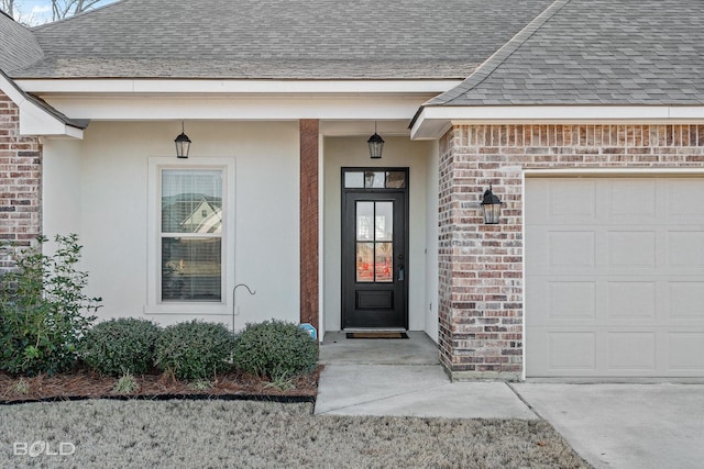 doorway to property with a garage