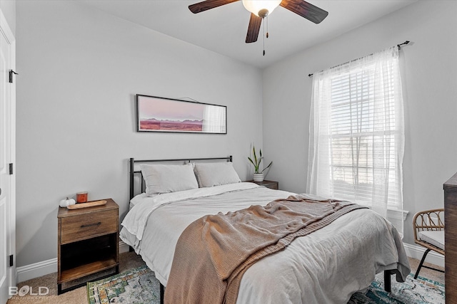 bedroom featuring ceiling fan and carpet