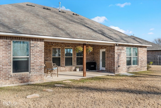 back of house with a lawn and a patio area