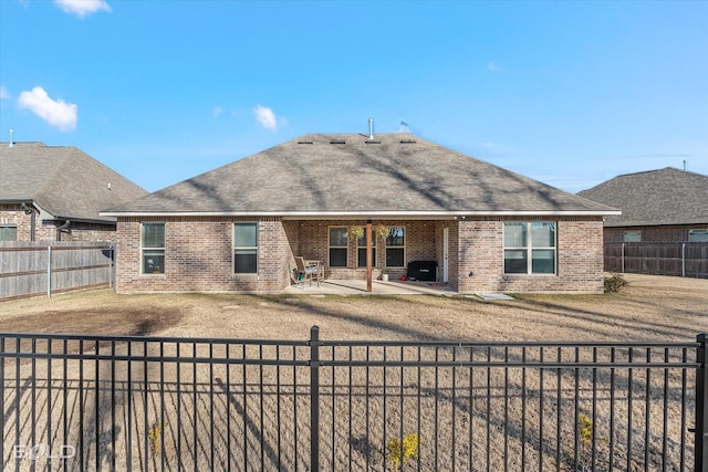 rear view of property featuring a patio and a lawn