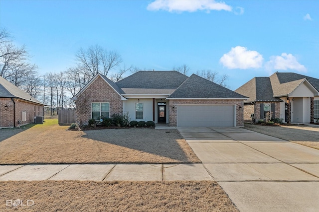 view of front of home with central AC and a garage