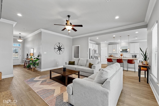 living room featuring ornamental molding and ceiling fan