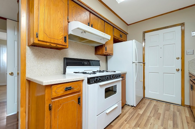 kitchen with white appliances, ornamental molding, light hardwood / wood-style flooring, and tasteful backsplash