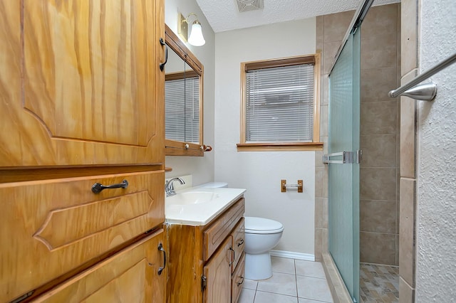 bathroom featuring toilet, tile patterned flooring, walk in shower, and a textured ceiling