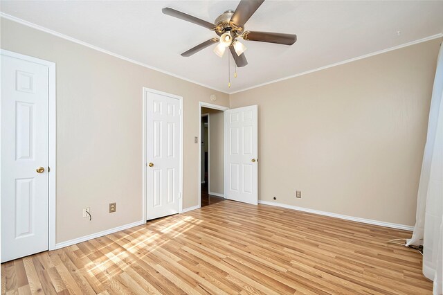 unfurnished bedroom featuring ceiling fan, ornamental molding, and light hardwood / wood-style flooring