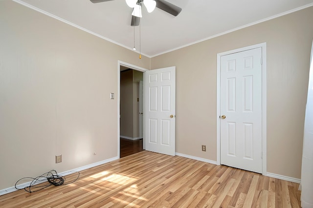 unfurnished bedroom with ceiling fan, light hardwood / wood-style floors, and crown molding