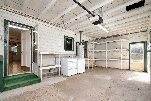 unfurnished sunroom with wood ceiling, separate washer and dryer, beamed ceiling, and gas water heater