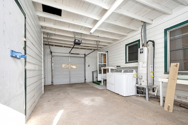 garage featuring gas water heater, independent washer and dryer, and a garage door opener