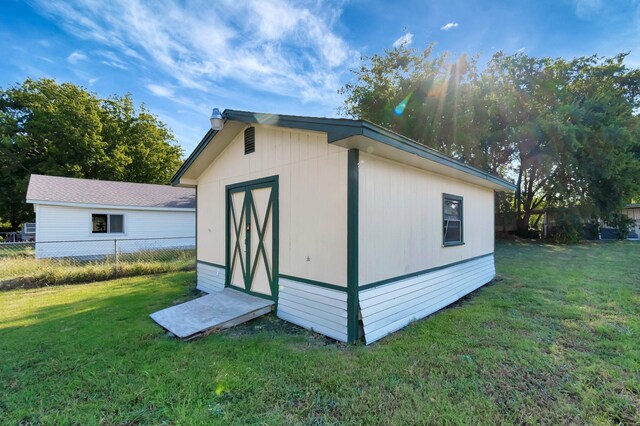 view of outbuilding featuring a lawn