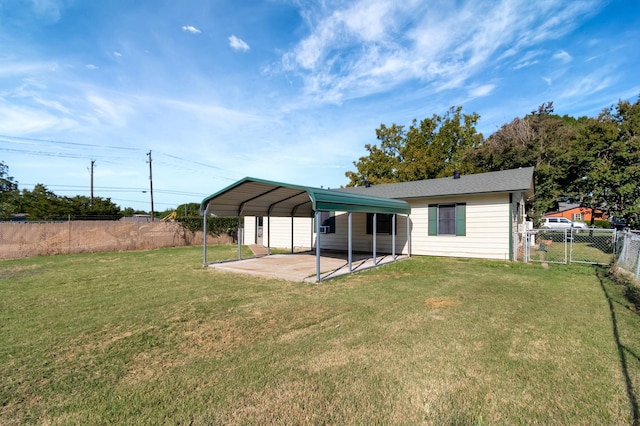 back of property with a yard and a carport