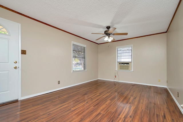 spare room with a textured ceiling, ceiling fan, ornamental molding, dark hardwood / wood-style floors, and cooling unit