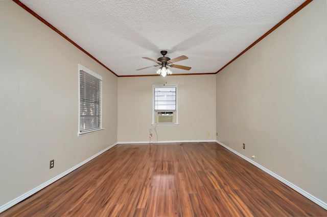 empty room featuring a textured ceiling, ceiling fan, ornamental molding, dark hardwood / wood-style floors, and cooling unit