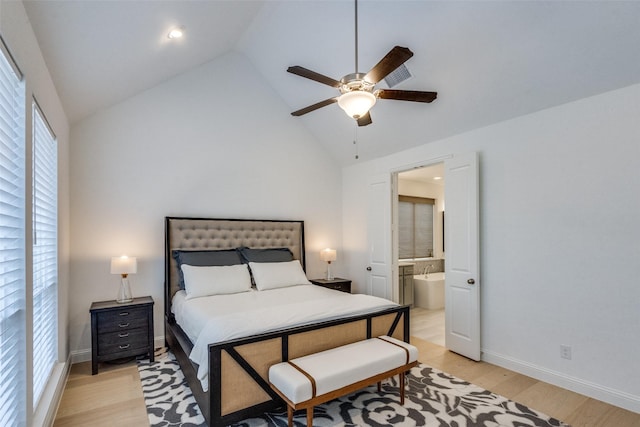 bedroom with vaulted ceiling, ensuite bath, ceiling fan, and light hardwood / wood-style floors