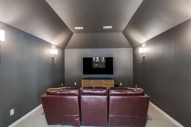 cinema with vaulted ceiling and carpet floors