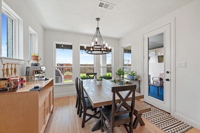 dining room featuring light hardwood / wood-style flooring and a chandelier