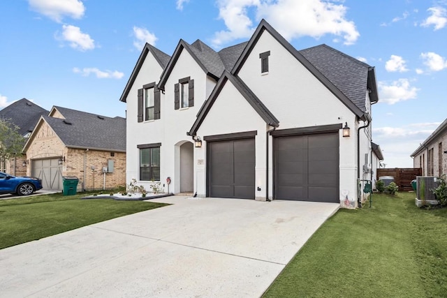 view of front of home featuring central AC unit, a front lawn, and a garage