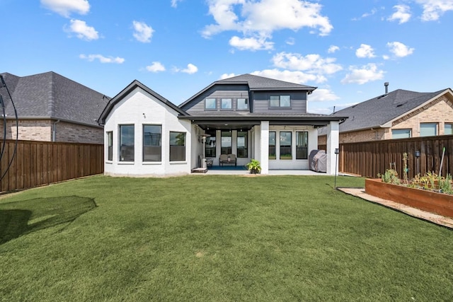 back of property with a patio and a lawn