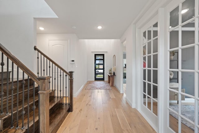 entryway featuring french doors and light hardwood / wood-style flooring