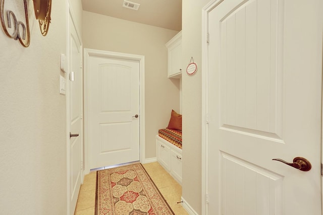 mudroom with visible vents and light tile patterned flooring