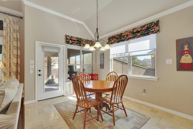 dining space featuring vaulted ceiling, ornamental molding, a chandelier, and baseboards